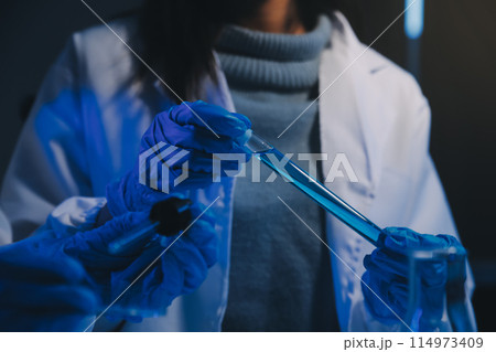 chemist,scientist hand dropping chemical liquid into test tube, science research and development concept chemist,scientist hand dropping chemical liquid into test tube, science research and development concept 114973409