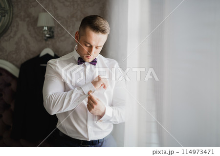 Beautiful man, groom posing and preparing for wedding Beautiful man, groom posing and preparing for wedding 114973471