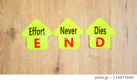 END effort never dies symbol. Concept words END effort never dies on beautiful yellow paper. Beautiful wooden background. Business END effort never dies concept. Copy space. 114973840