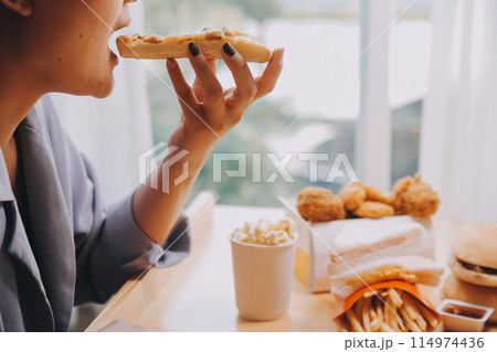 Cropped image of woman holding pizza slice at restaurant Cropped image of woman holding pizza slice at restaurant 114974436