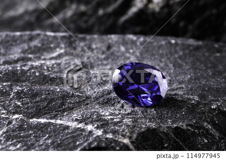 blue sapphire on black stone background blue sapphire on black stone background 114977945