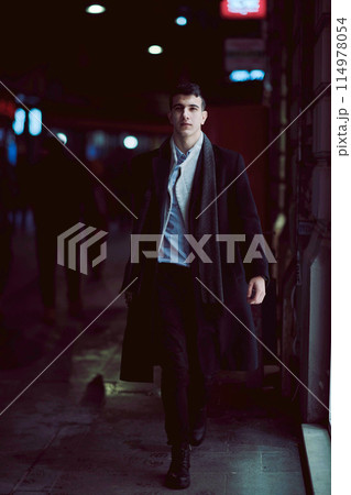 Smiling Meedle Eastern man walking down street near modern office building, 114978054