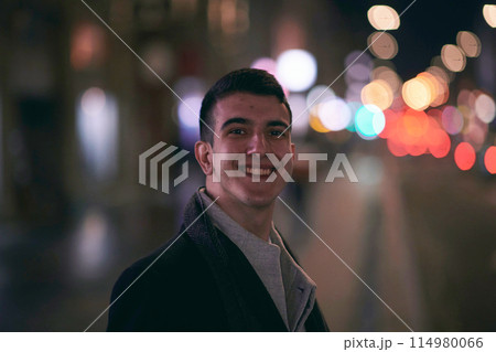 Smiling Meedle Eastern man walking down street near modern office building, Smiling Meedle Eastern man walking down street near modern office building, 114980066