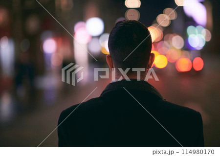 Smiling Meedle Eastern man walking down street near modern office building, 114980170