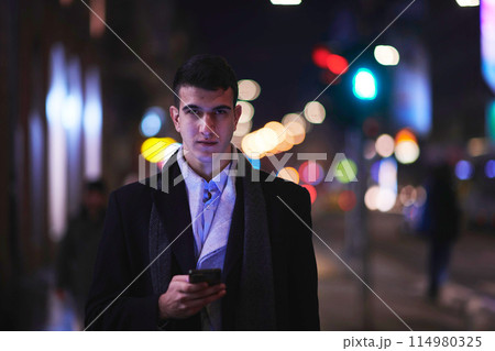 Smiling Meedle Eastern man walking down street near modern office building, 114980325