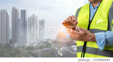 Civil engineer architect Using a smartphone to communicate and give orders to the construction team, Engineer building concept, Background for construction, Technology to construction. 114980495
