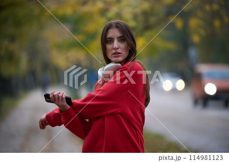 Athletic young woman taking a breath and relaxing after jogging and stretching. Woman Training and Workout Exercises On Street. 114981123