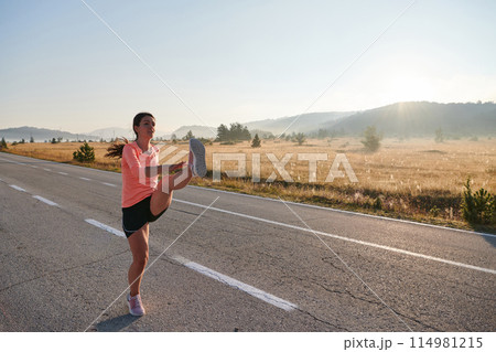 Determined Stretch: Athletic Woman Embraces Post-Run Flexibility in Nature. Determined Stretch: Athletic Woman Embraces Post-Run Flexibility in Nature. 114981215
