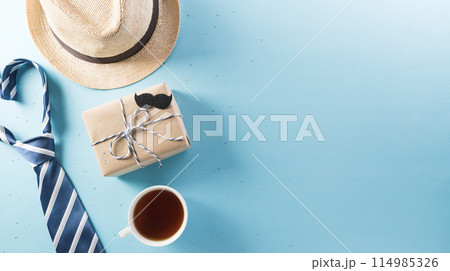 Happy Fathers Day background concept with gift box, decorated bow tie, necktie and mustache on bright pastel background. 114985326