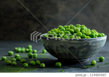 Fresh green peas in bowl on dark rustic background. 114985897