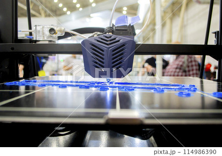 3D printer working close-up. 3D printer prints model from molten plastic close-up. 3D printer printing object. Additive progressive high-tech technology. New modern prototyping technologies. 114986390