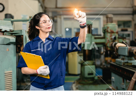 professional engineer worker with safety eyes protection focus working in metal lathe milling machine heavy industry factory. professional engineer worker with safety eyes protection focus working in metal lathe milling machine heavy industry factory. 114988122