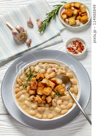 rosemary garlic creamy white bean soup in bowl 114988849