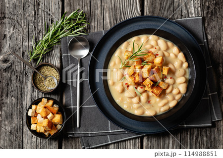rosemary garlic creamy white bean soup in bowl 114988851