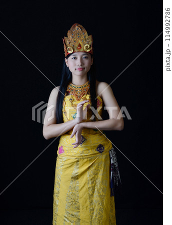 Indonesian Woman in Traditional Dance Pose Indonesian Woman in Traditional Dance Pose 114992786