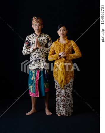 Indonesian Man and Woman in Traditional Greeting Indonesian Man and Woman in Traditional Greeting 114992788