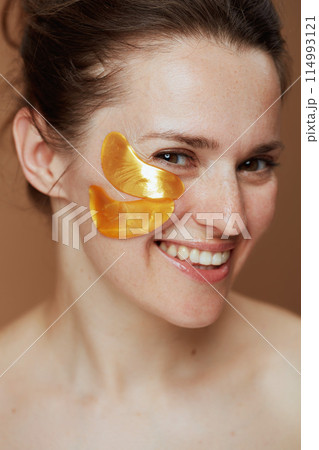 smiling young woman with eye patches 114993121