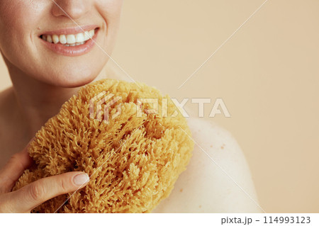 Closeup on woman with sea sponge Closeup on woman with sea sponge 114993123