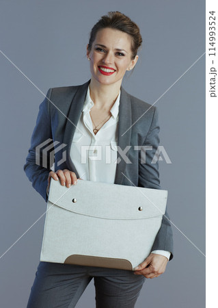 happy business woman isolated on grey background happy business woman isolated on grey background 114993524