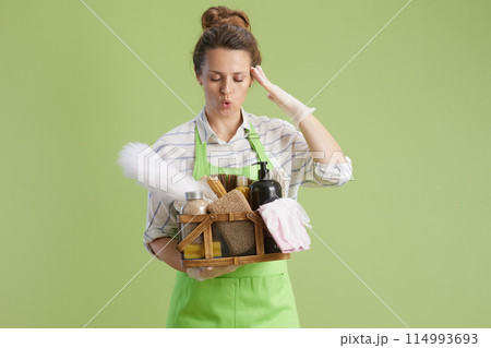 stressed modern woman isolated on green background stressed modern woman isolated on green background 114993693