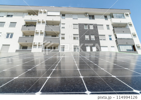 Solar panels near an apartment building 114994126