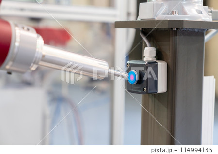 Industrial Robot presses the button. Accuracy calibration 114994135
