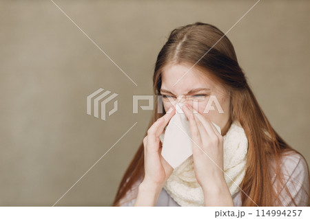 Young woman blowing nose has flu catarrh ill sick disease treatment cold Young woman blowing nose has flu catarrh ill sick disease treatment cold 114994257