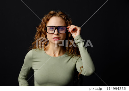 Happy smiling young businesswoman wearing glasses looking at camera with joyful smile. Business girl concept. Happy smiling young businesswoman wearing glasses looking at camera with joyful smile. Business girl concept. 114994286