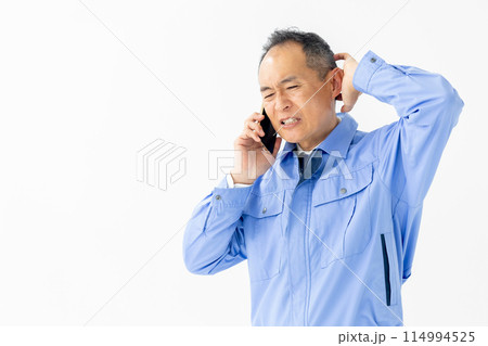 作業服の男性　スマホ　通話　困る 114994525