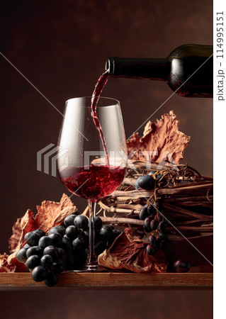 Wine is poured into a glass. Wine is poured into a glass. 114995151