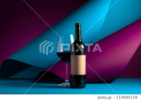 Bottle and glass of red wine. 114995159