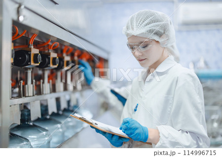 Women worker work in drink water factory inspect check quality drinking water filling machine control operate Women worker work in drink water factory inspect check quality drinking water filling machine control operate 114996715