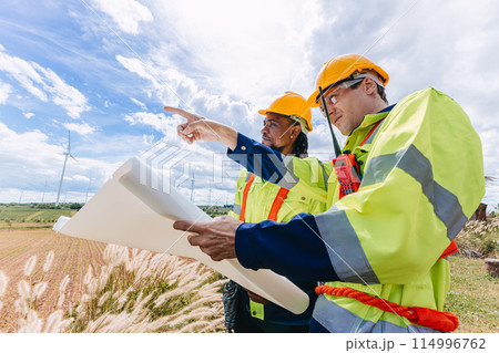 Engineer team working group survey at wind turbine clean power generator service maintenance wind mill outdoor. 114996762