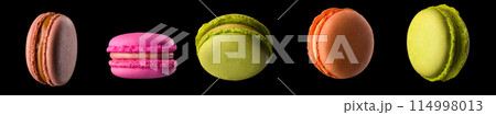 Macro photo of french caramel macaroon or macaron isolated on black background Macro photo of french caramel macaroon or macaron isolated on black background 114998013
