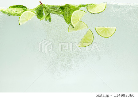 Textured photo. Abstract wallpaper. Close-up view of glass of water infused with lime and mint. Refreshing Mojito drink. Textured photo. Abstract wallpaper. Close-up view of glass of water infused with lime and mint. Refreshing Mojito drink. 114998360