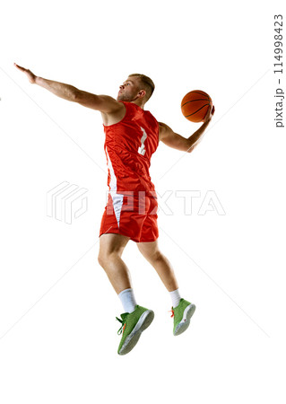 Side view portrait of young sporty man, dressed red uniform scoring goal in motion against white studio background. 114998423