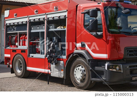 A state-of-the-art firetruck, equipped with advanced rescue technology, stands ready with its skilled firefighting team, prepared to intervene and respond rapidly to emergencies, ensuring the safety A state-of-the-art firetruck, equipped with advanced rescue technology, stands ready with its skilled firefighting team, prepared to intervene and respond rapidly to emergencies, ensuring the safety 115000313