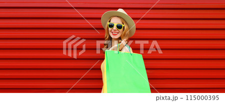 Shopping day! Stylish beautiful happy smiling young woman with green shopping bags, wear summer hat Shopping day! Stylish beautiful happy smiling young woman with green shopping bags, wear summer hat 115000395