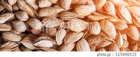 unpeeled almond kernels in a shell on market counter close-up unpeeled almond kernels in a shell on market counter close-up 115000515