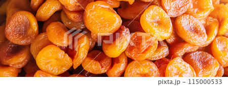 Orange dried apricots in close-up. Dried apricots on counter at market Orange dried apricots in close-up. Dried apricots on counter at market 115000533