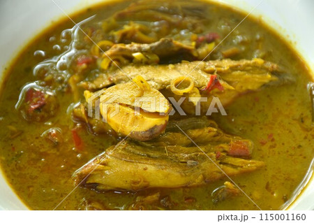 spicy Thai southern grilled mackerel and organ in coconut milk curry soup on bowl spicy Thai southern grilled mackerel and organ in coconut milk curry soup on bowl 115001160
