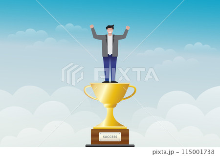 a man stands on a trophy with his hands raised against a cloudy blue sky background a man stands on a trophy with his hands raised against a cloudy blue sky background 115001738
