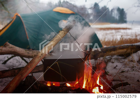 picnic in winter on nature of a bonfire 115002579