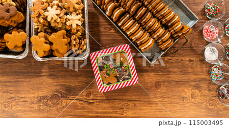 Lovingly homemade gingerbread and sugar cookies, half-dipped in rich chocolate, nestled in decorative Christmas tin boxes perfect for seasonal gifting. 115003495