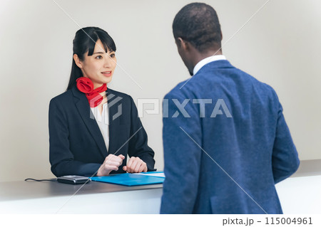 カウンターで外国人訪問者を接客する女性 115004961