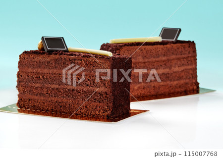 Slices of chocolate cake topped with crunchy streusel on blue background 115007768