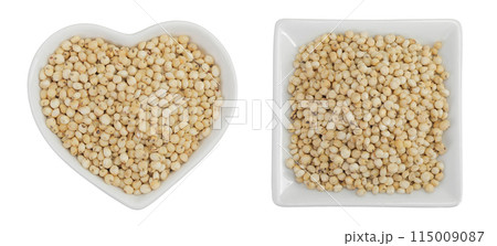 Sorghum seeds in ceramic bowl isolated on white background. Top view. Flat lay. 115009087