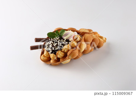 Trendy Hong Kong bubble waffles with ice cream, cream and berries on white wooden background. Copy space 115009367