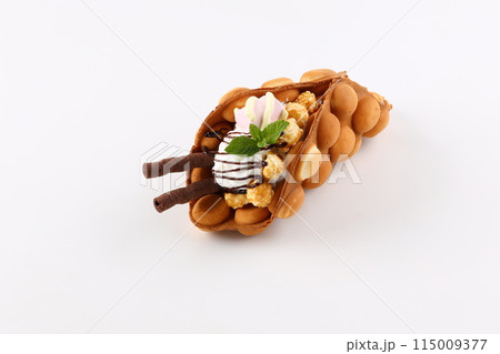 Trendy Hong Kong bubble waffles with ice cream, cream and berries on white wooden background. Copy space 115009377