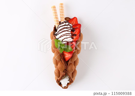 Hong kong or bubble waffle with ice cream, chocolate, marshmallows and strawberries isolated on white background 115009388